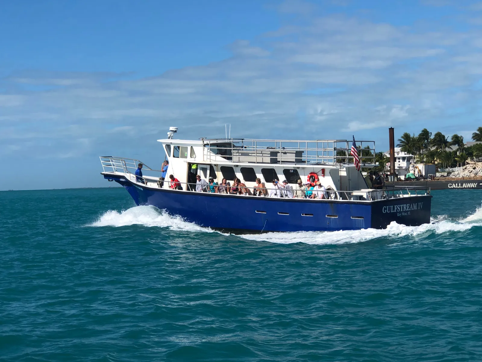 Gulfstream IV party boat underway in Key West waters flying the American flag